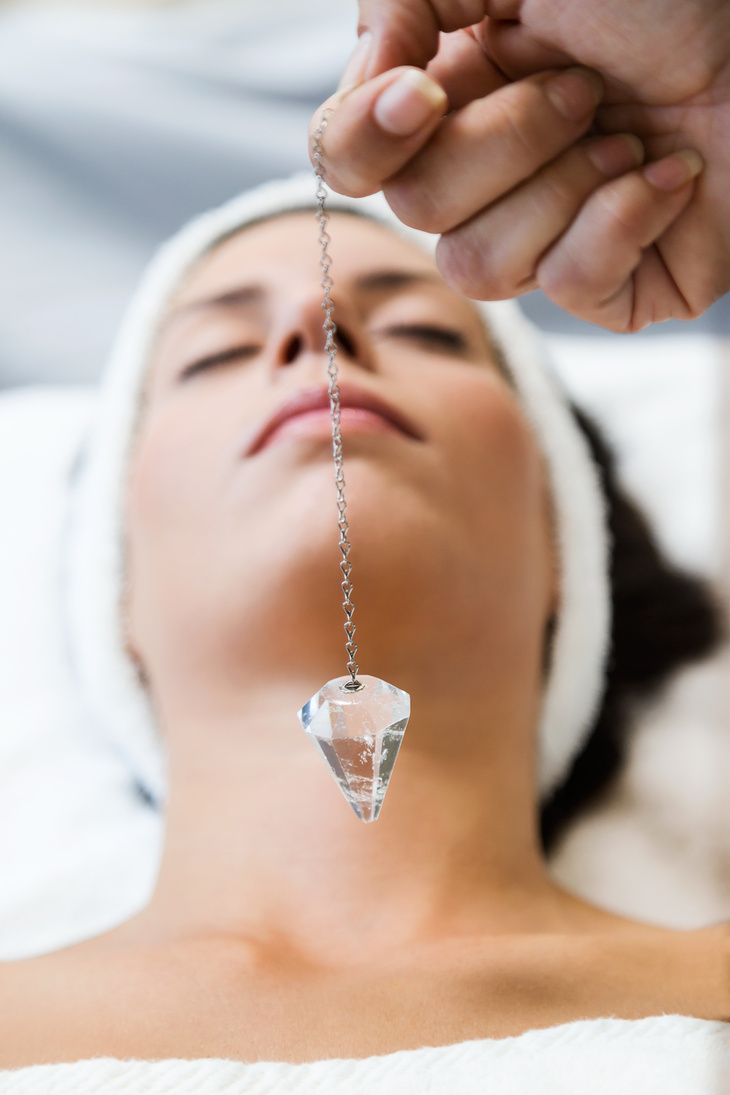 Woman Receiving Gemstone Therapy in Spa